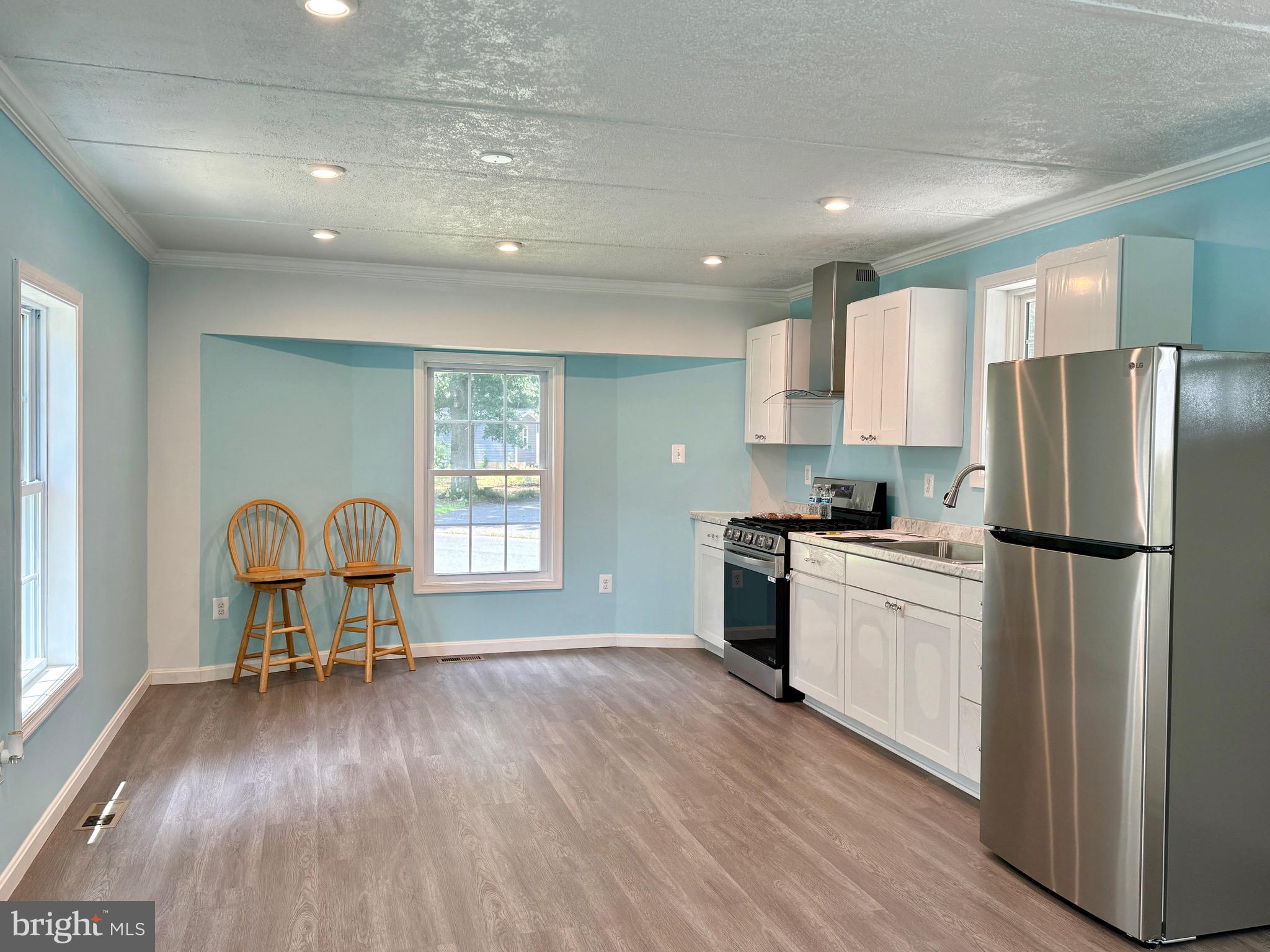 10130 Cherry Street Laurel, DE 19956 - Photo 27 of 47 a kitchen with a refrigerator and a stove top oven