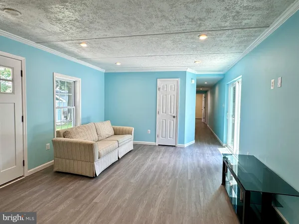 a kitchen with a white cabinets and wooden floor