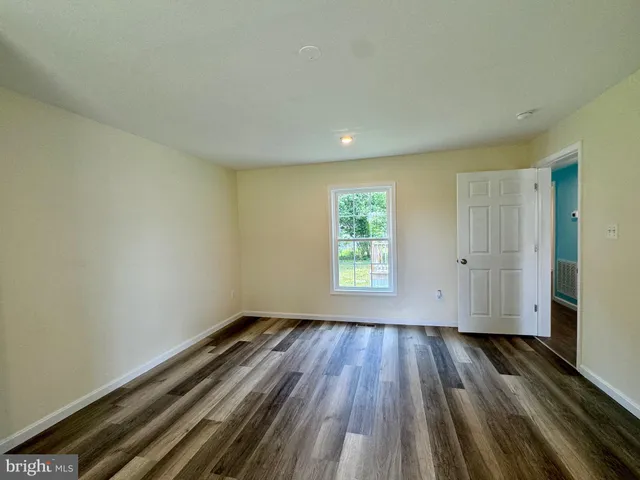 a view of a room with wooden floor and cabinet