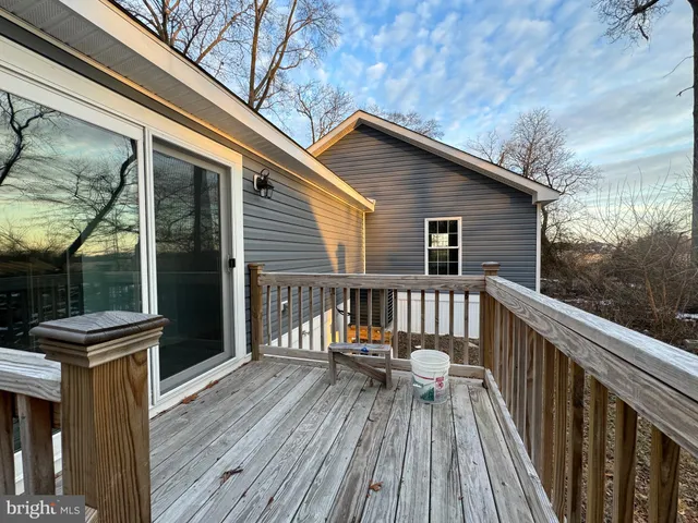 a balcony with wooden floors and furniture