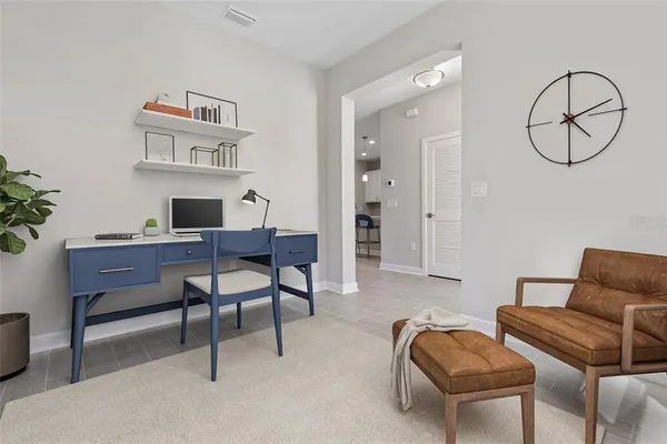 a view of a livingroom with furniture and a potted plant