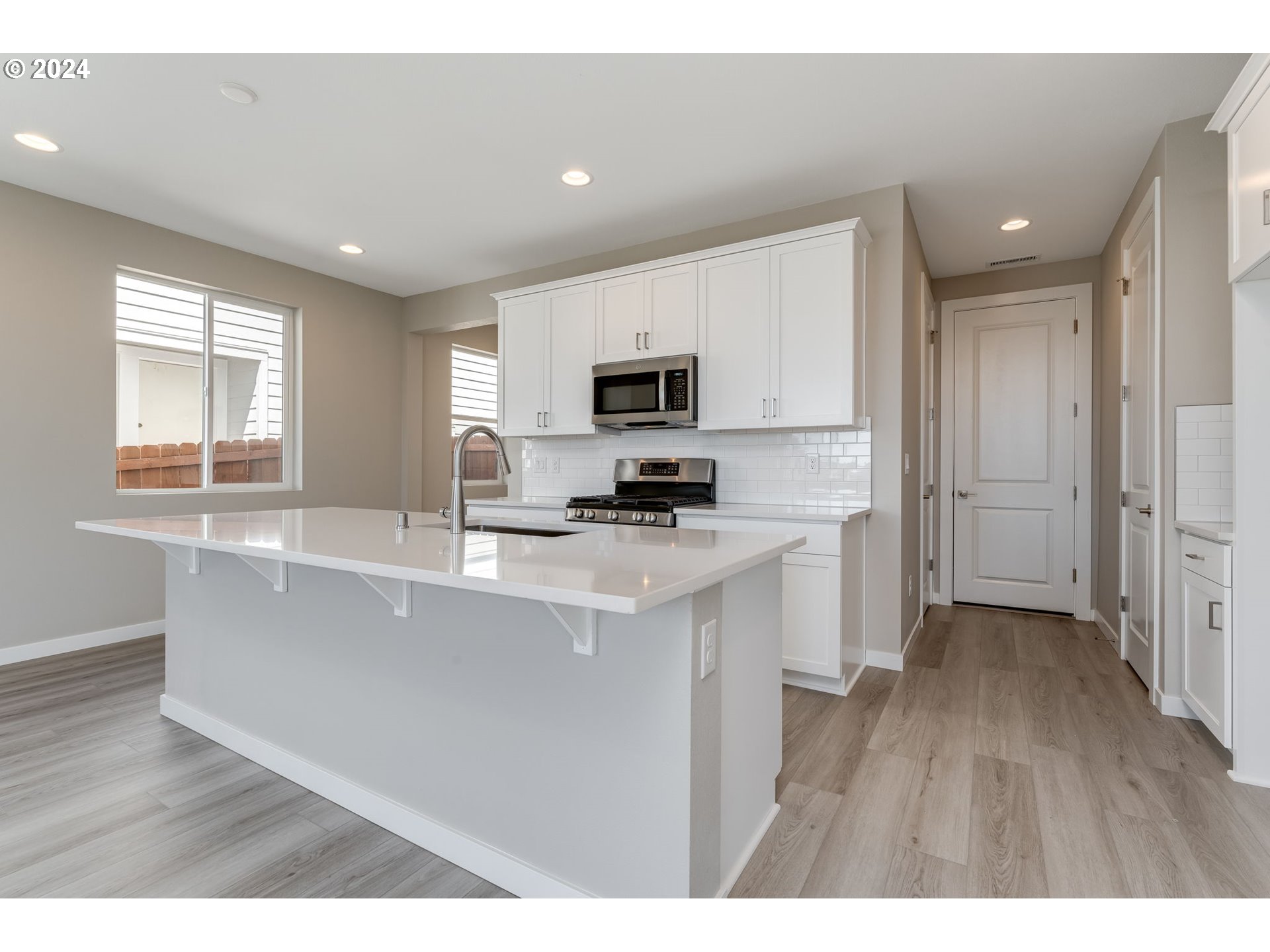 737 Northwest 178th Street Ridgefield, WA 98642 - Photo 6 of 39 a kitchen with stainless steel appliances granite countertop a stove a sink and a refrigerator