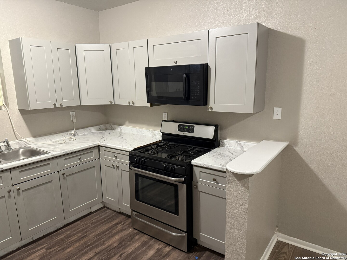 378 East Petaluma Boulevard San Antonio, TX 78221 - Photo 11 of 14 a kitchen with a sink stove and microwave