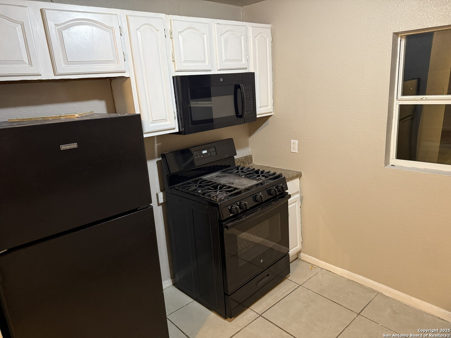 378 East Petaluma Boulevard San Antonio, TX 78221 - Photo 12 of 14 a stove top oven sitting inside of a kitchen