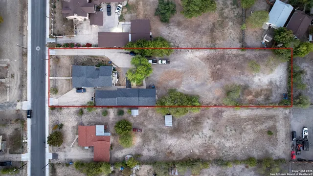 an aerial view of a house with a yard