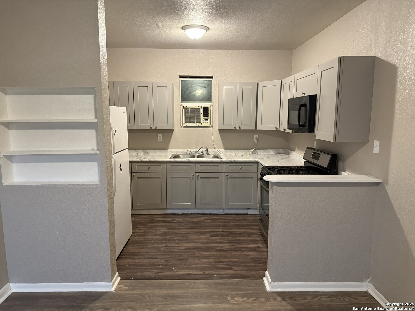 378 East Petaluma Boulevard San Antonio, TX 78221 - Photo 6 of 14 a kitchen with stainless steel appliances granite countertop a sink stove and refrigerator