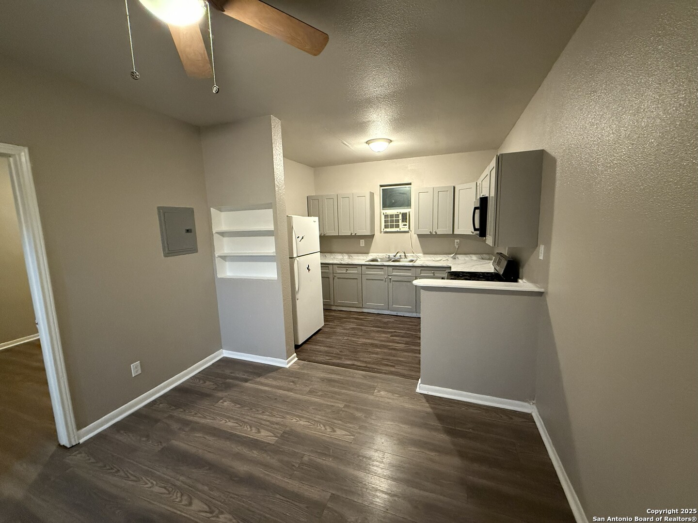 378 East Petaluma Boulevard San Antonio, TX 78221 - Photo 7 of 14 a kitchen with a refrigerator and a stove top oven
