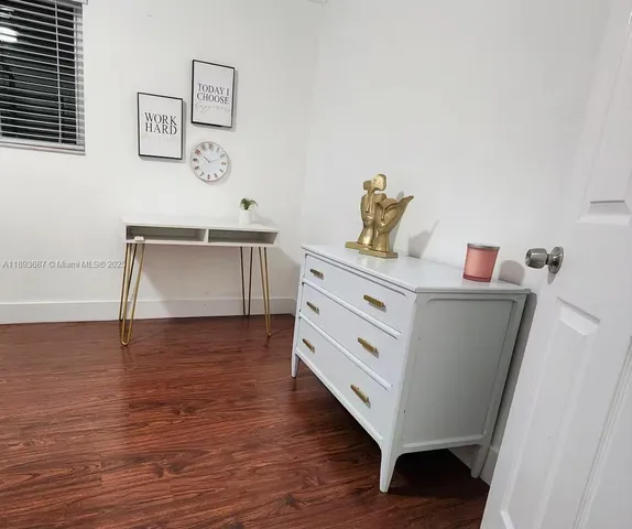 a room with furniture and wooden floor