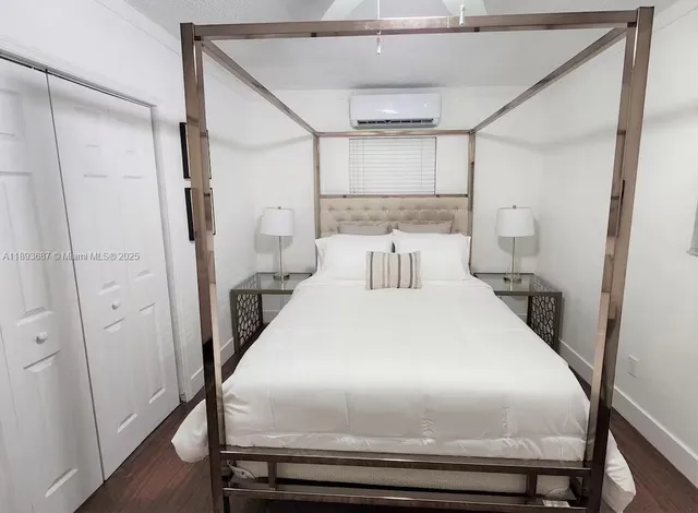 a bedroom with a bed and a mirror