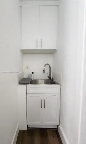 a view of a sink with cabinets