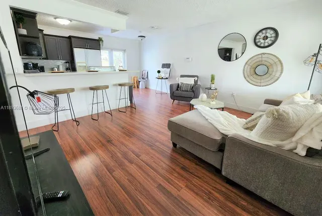 a living room with furniture and a mirror