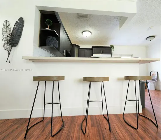 a kitchen with a white wooden floor and window