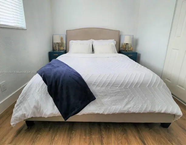 a bedroom with a bed and a black walk in closet