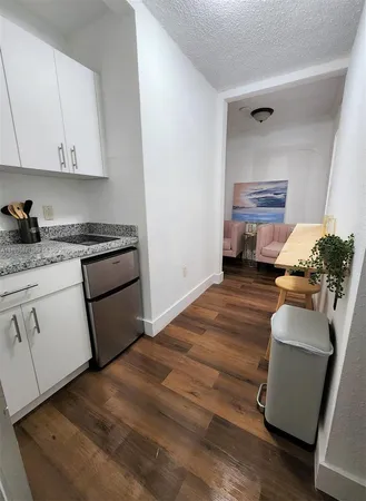 a kitchen with sink refrigerator and stove
