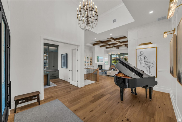 2608 Canyon Ridge Drive St. George, UT 84770 - Photo 7 of 86 Grand entryway featuring wood-finish flooring, a contemporary chandelier, and wainscoting detailing