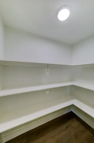 a view of a kitchen with wooden floor and a kitchen
