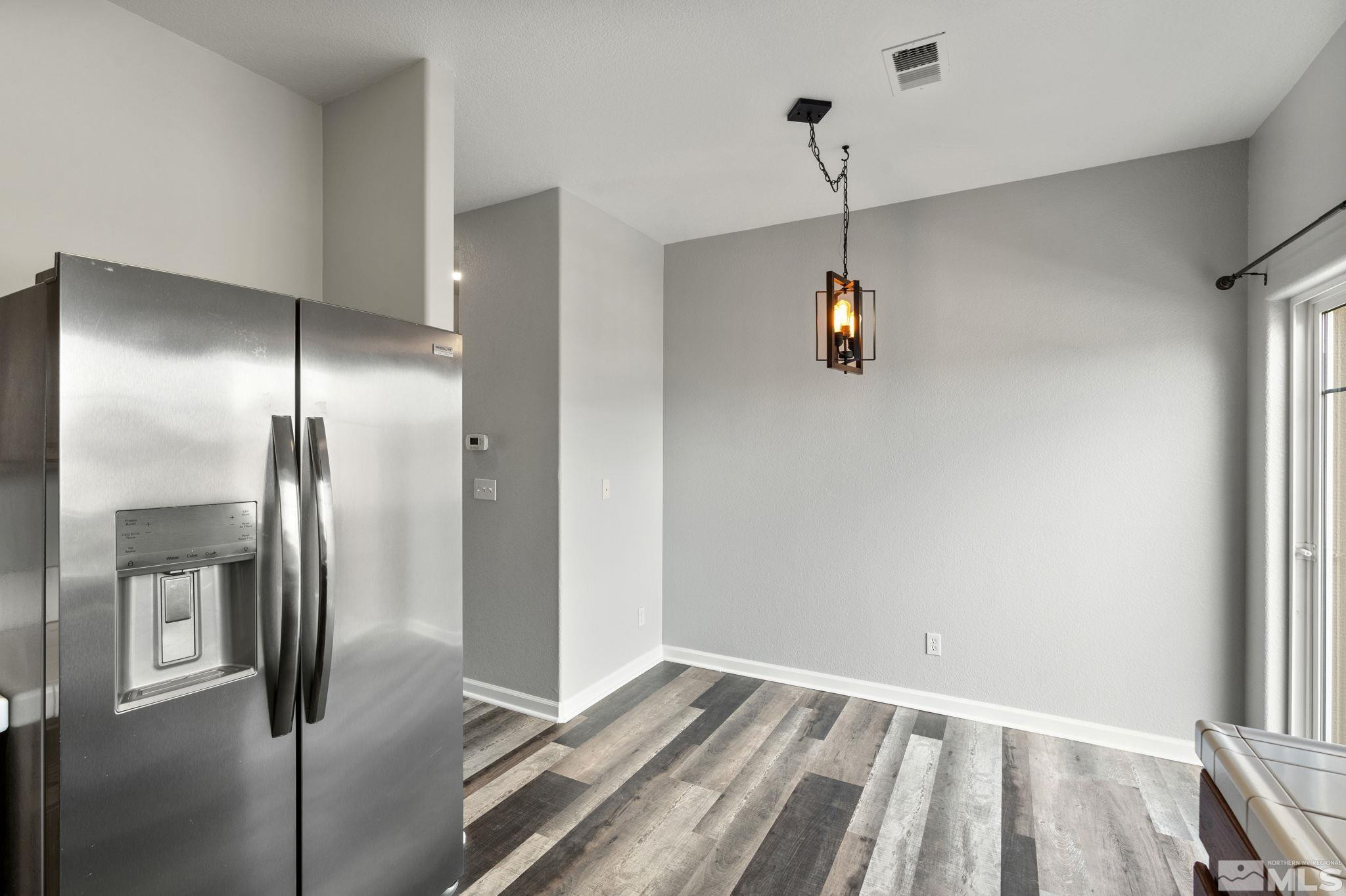 345 Madison Marie Lane Reno, NV 89503 - Photo 13 of 34 a view of a refrigerator in kitchen and wooden floor