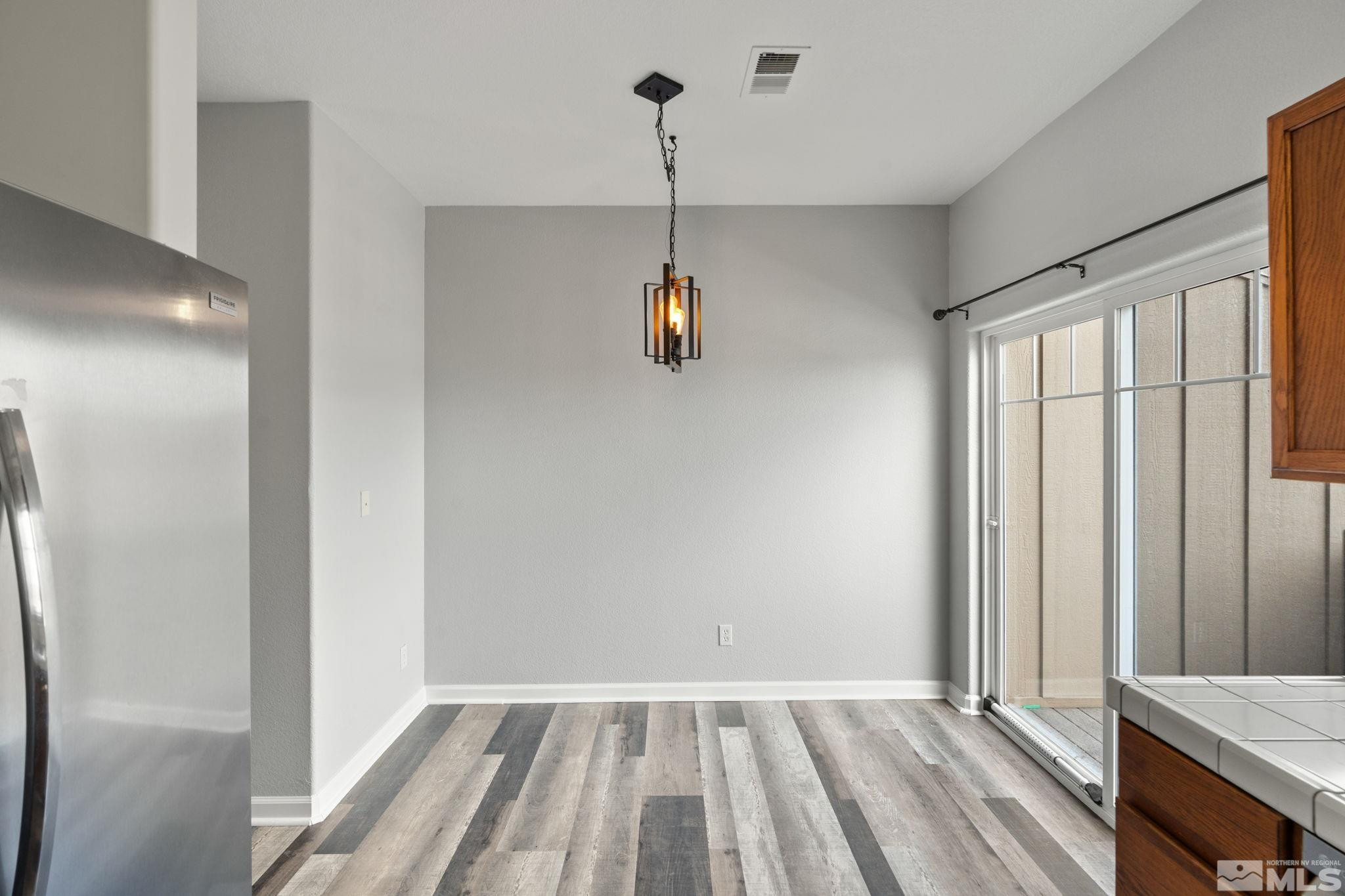 345 Madison Marie Lane Reno, NV 89503 - Photo 14 of 34 a view of a room with wooden floor and windows