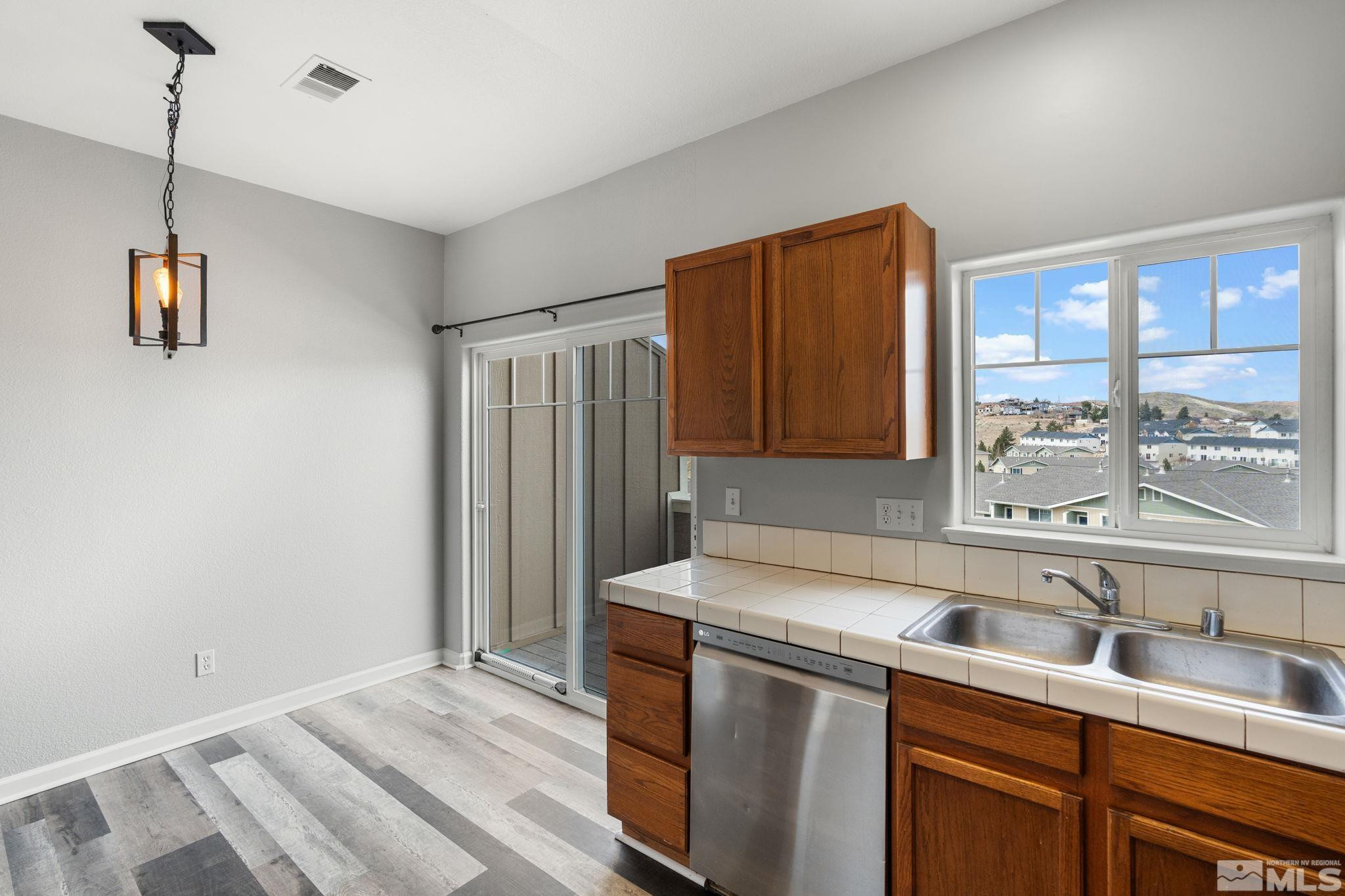 345 Madison Marie Lane Reno, NV 89503 - Photo 15 of 34 a kitchen that has a sink cabinets counter space and a window