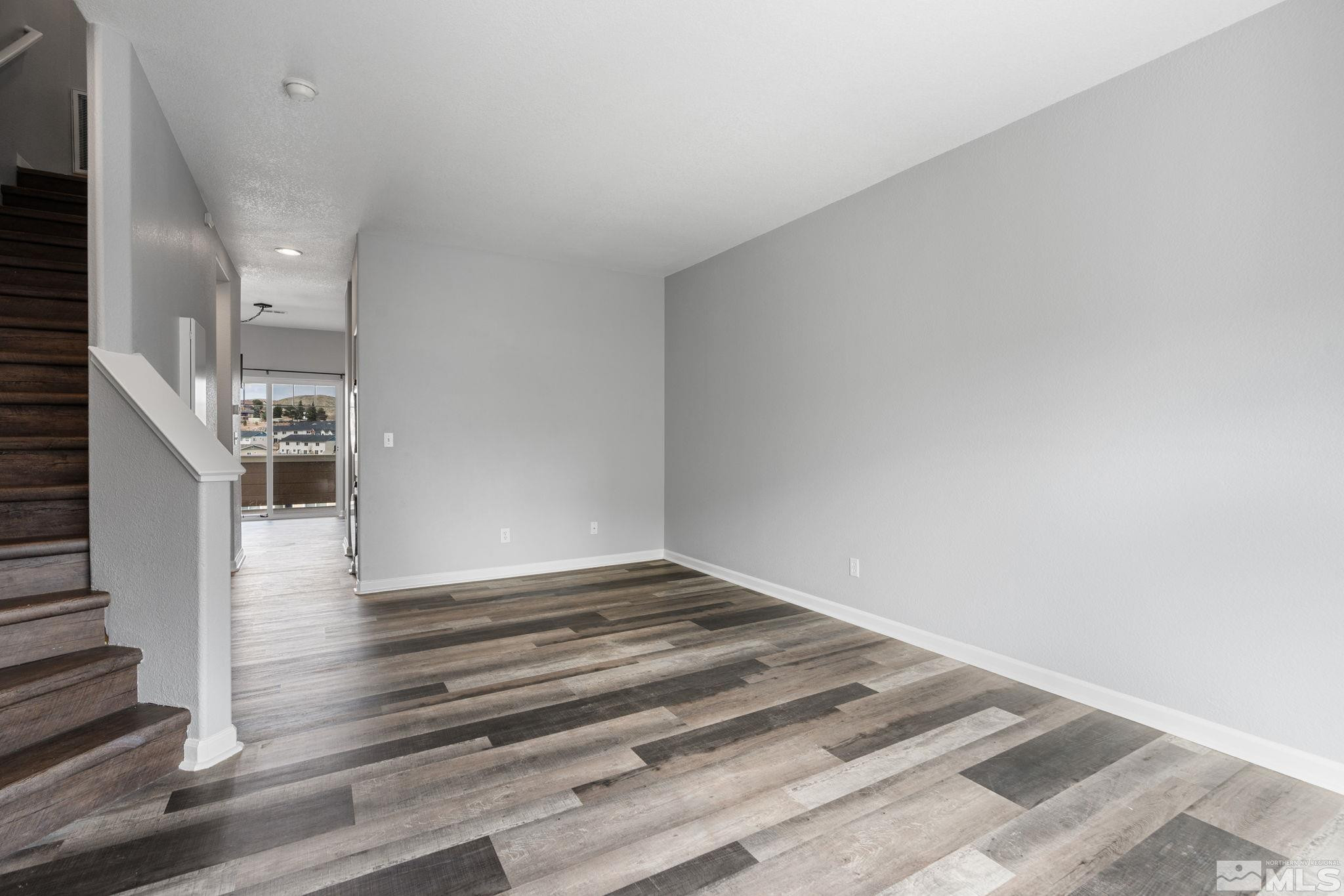345 Madison Marie Lane Reno, NV 89503 - Photo 6 of 34 a view of an empty room and wooden floor