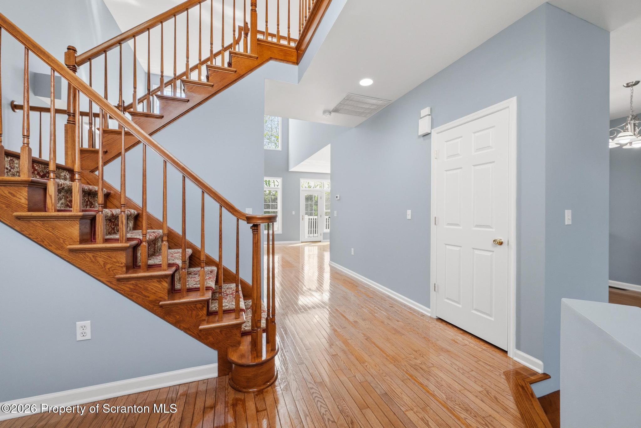 1502 Verne Cl Moosic, PA 18507 - Photo 3 of 46 a view of staircase with lots of frames on wall and wooden floor