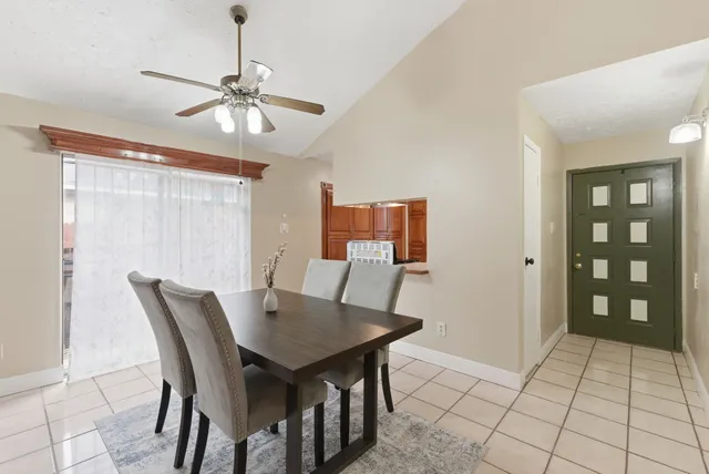 a view of a dining room with furniture and chandelier