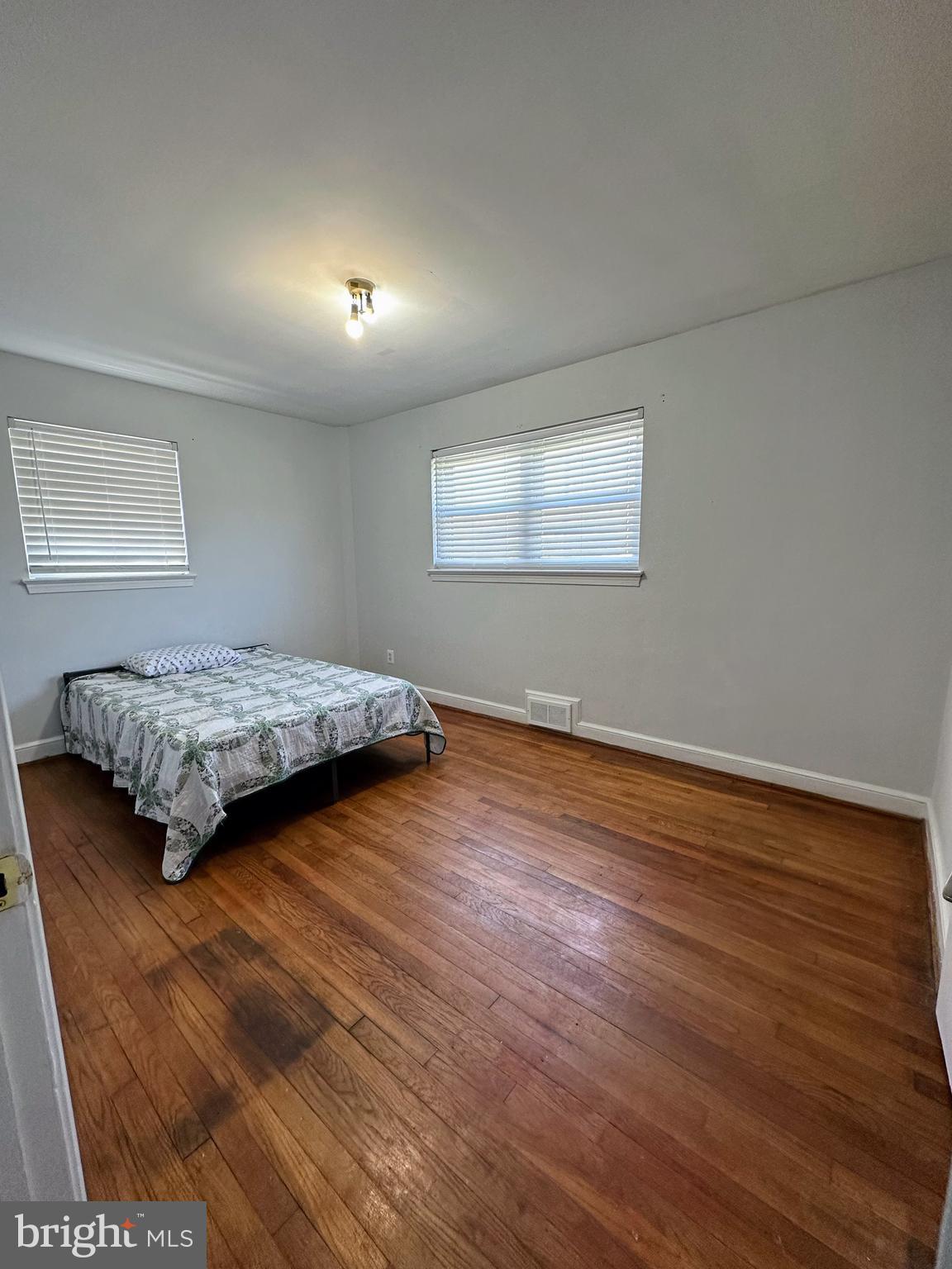 6019 Craig Street Springfield, VA 22150 - Photo 8 of 30 a bedroom with a bed and wooden floor