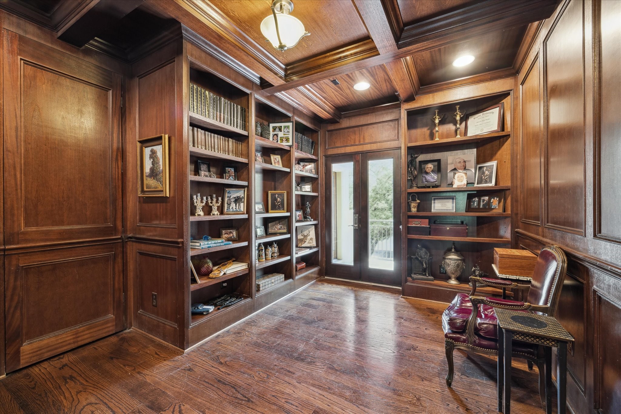 2247 Bartlett Street Houston, TX 77098 - Photo 27 of 50 Attractive wood paneled home office with floor to ceiling built-ins and double door access to patio.