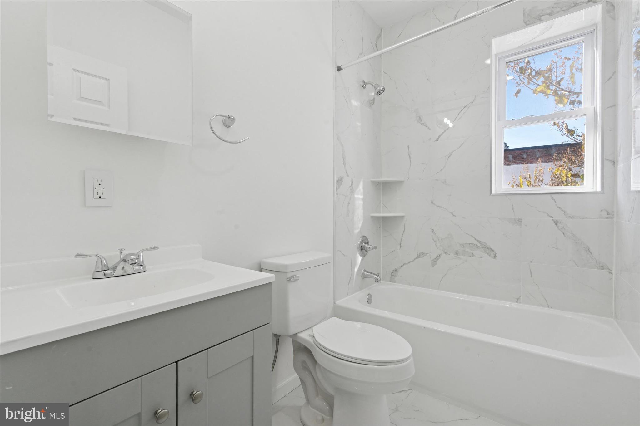 3827 Cambridge Street, Unit 1 Philadelphia, PA 19104 - Photo 5 of 7 a bathroom with a sink toilet and bathtub