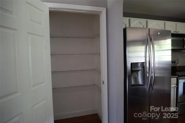 a kitchen with a refrigerator and a refrigerator