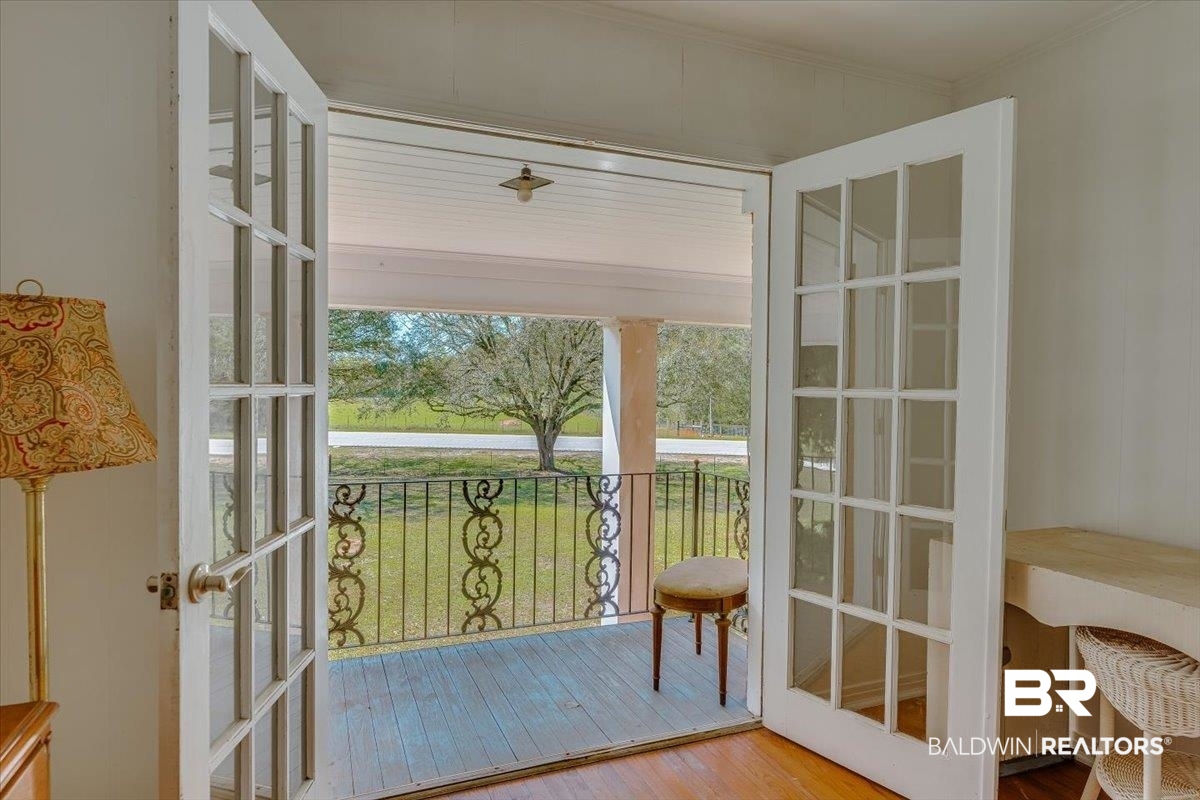 14160 Moffett Road Wilmer, AL 36587 - Photo 44 of 75 Entryway featuring hardwood / wood-style floors, crown molding, and french doors
