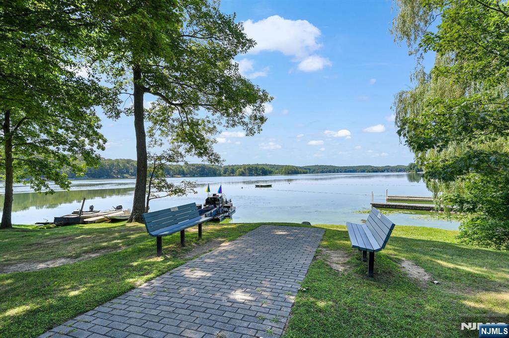 85 Breakneck Road Vernon, NJ 07422 - Photo 27 of 32 a view of a lake with couches and wooden fence