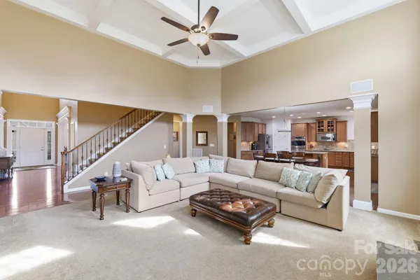 a living room with furniture and a ceiling fan