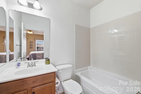 a bathroom with a sink toilet vanity and bathtub