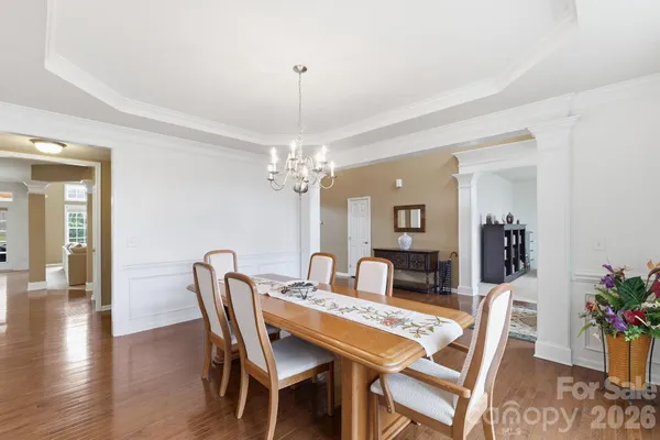 a view of a dining room with furniture and wooden floor