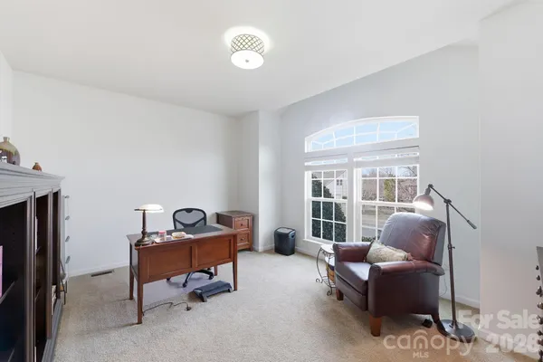 a livingroom with workspace and a window