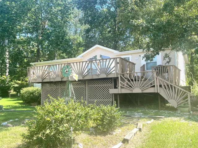 a view of a patio with a table chairs and a small yard
