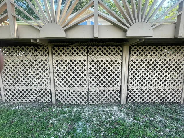 a backyard view of a black gate