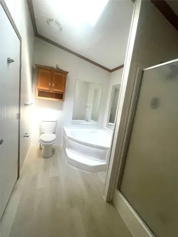 a bathroom with a toilet and a shower