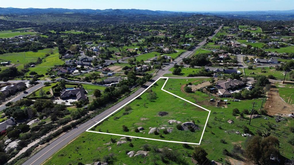30638 Pauma Heights Road Valley Center, CA 92082 - Photo 5 of 9 an aerial view of a golf course with lots of green space and mountain view in back