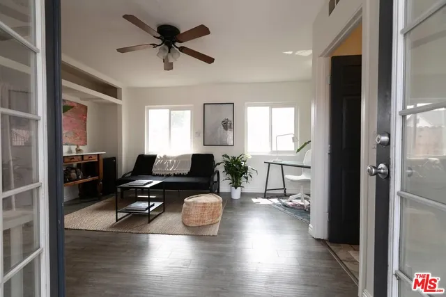 a living room with furniture and a potted plant