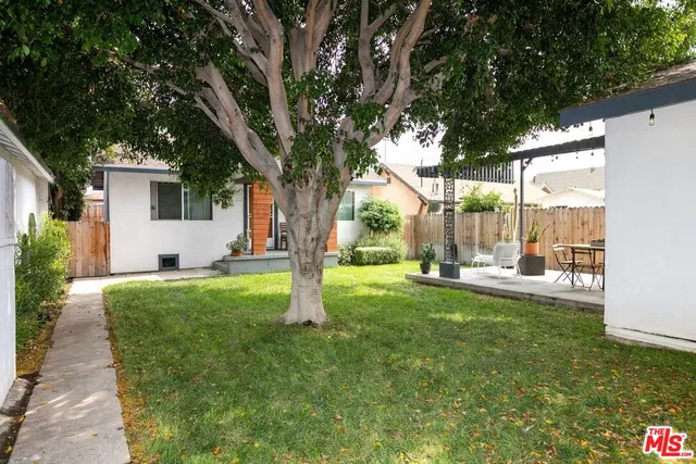 a building outdoor space with patio furniture and potted plants
