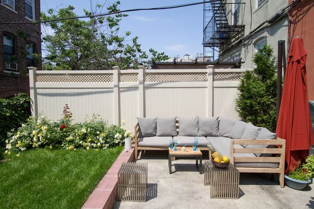 a view of a patio with couches table and chairs and potted plants