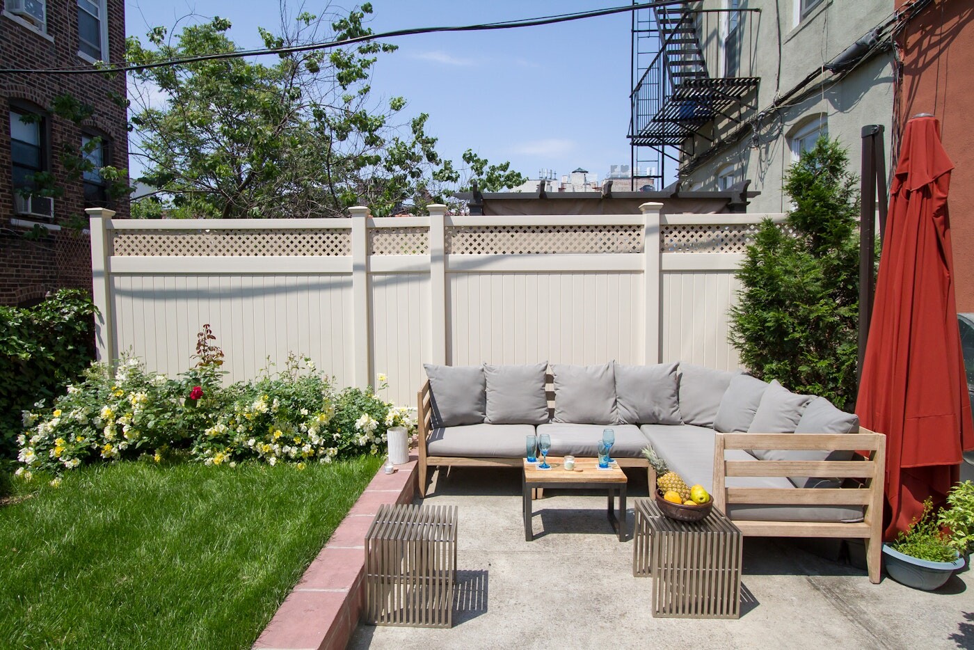 47-14 48th Street, Unit 1R Queens, NY 11377 - Photo 13 of 18 a view of a patio with couches table and chairs and potted plants