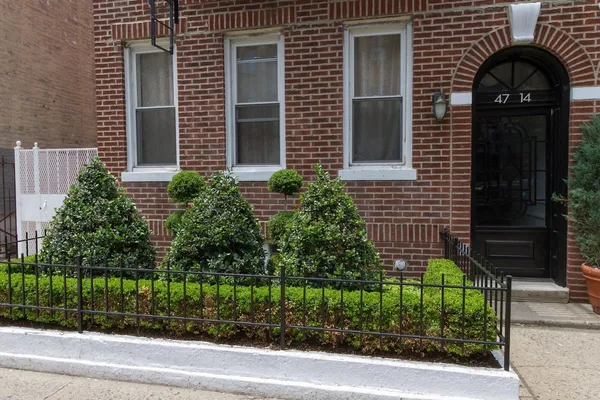 a view of a house with a window and flower plants