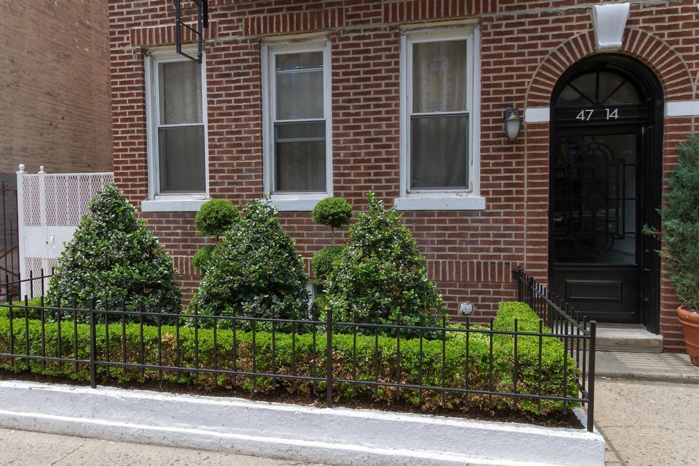 47-14 48th Street, Unit 1R Queens, NY 11377 - Photo 15 of 18 a view of a house with a window and flower plants
