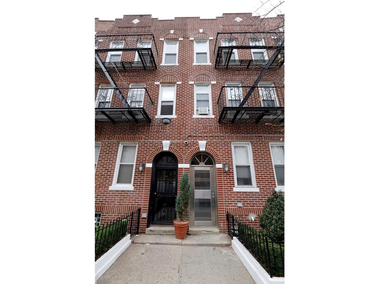 47-14 48th Street, Unit 1R Queens, NY 11377 - Photo 16 of 18 a front view of a house with a yard