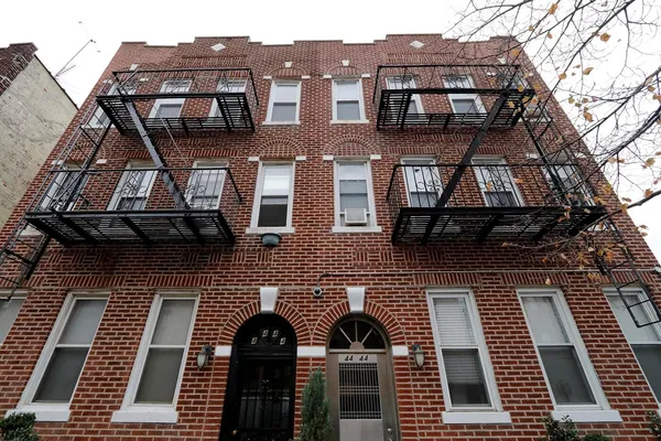 a view of a brick house with many windows