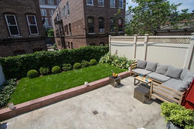a view of a patio with couches table and chairs with potted plants