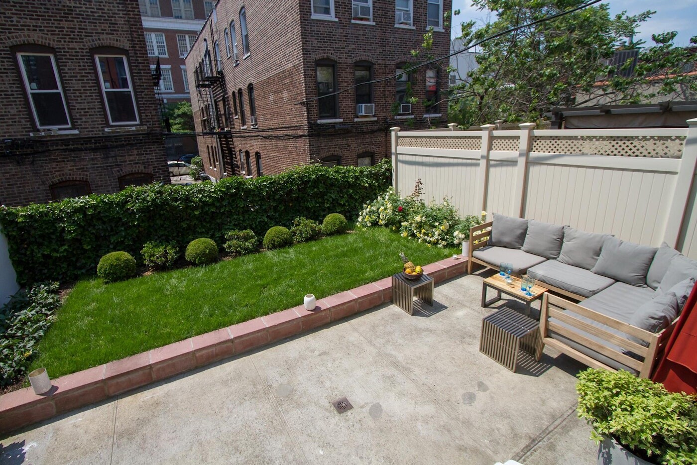47-14 48th Street, Unit 1R Queens, NY 11377 - Photo 10 of 18 a view of a patio with couches table and chairs with potted plants